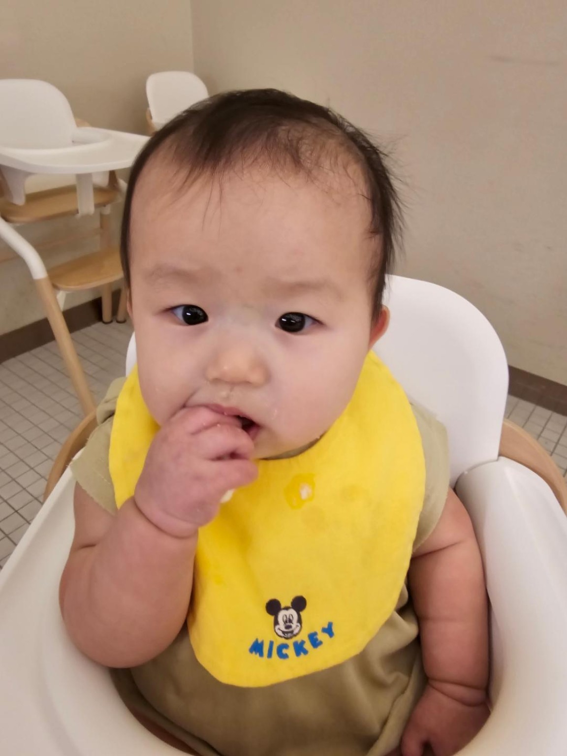 Our baby wearing a yellow bib